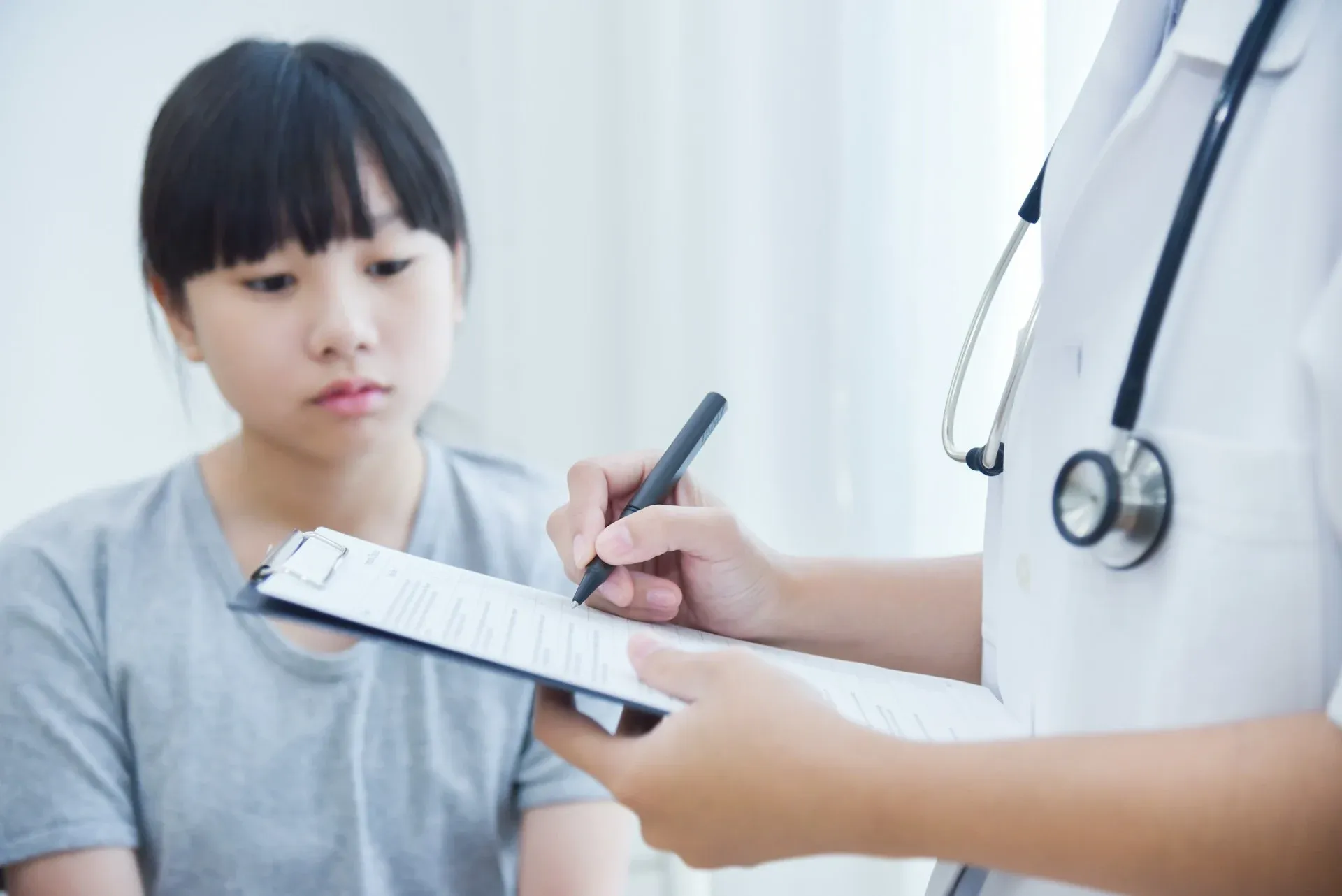 child undergoing health tests in turkey, including blood, vision screenings