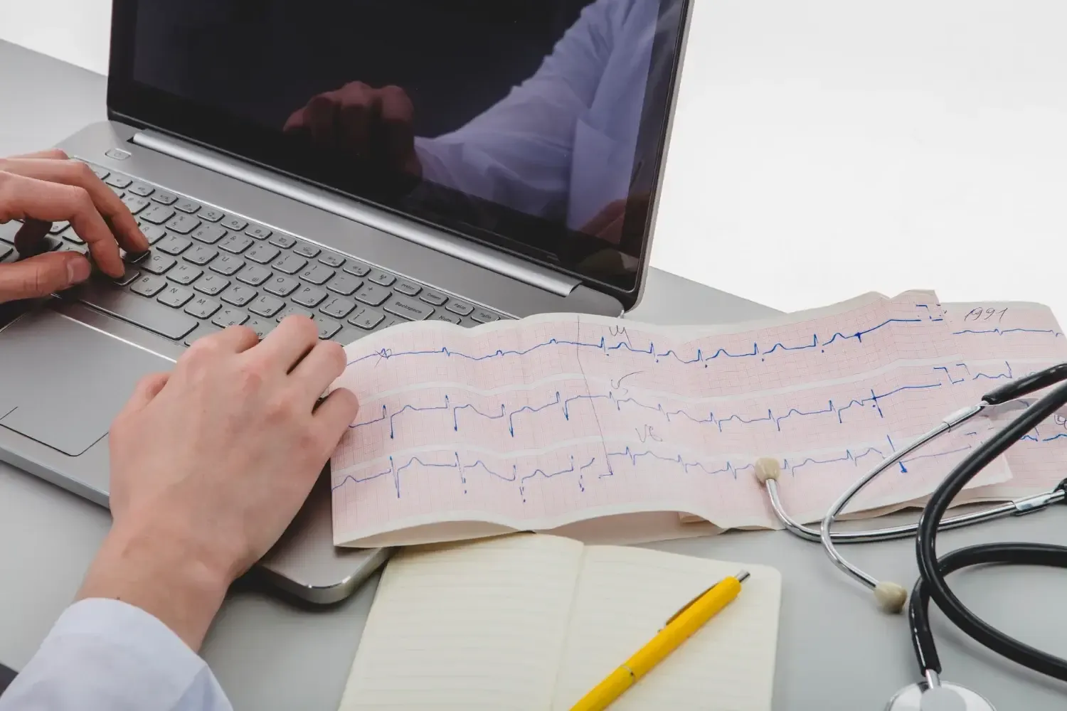 ecg results and a stethoscope on a clinical table